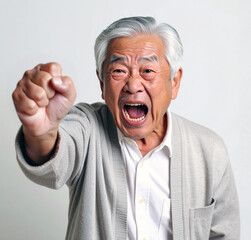 拳を突き出して激怒する高齢男性