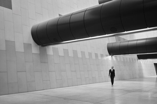 Modern minimal hallway architecture with geometric patterns and business attire