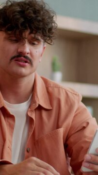 Frustrated Caucasian businessman with mobile phone feeling sad business man holding smartphone failure online problem internet connection lost trouble receive sms message bad news male guy in office