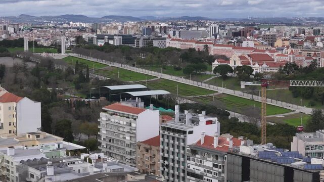 Aerial view of Lisbon's cityscape, showcasing Eduardo VII Park's green expanse contrasting with the urban architecture, Lisbon, Lisbon, Portugal.