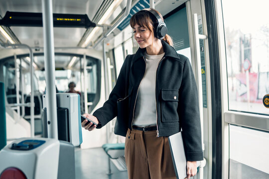 Entrepreneur using contactless payment for ticket on public transport