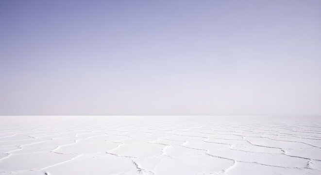 Expansive white landscape under a vast cloud filled sky with horizon line