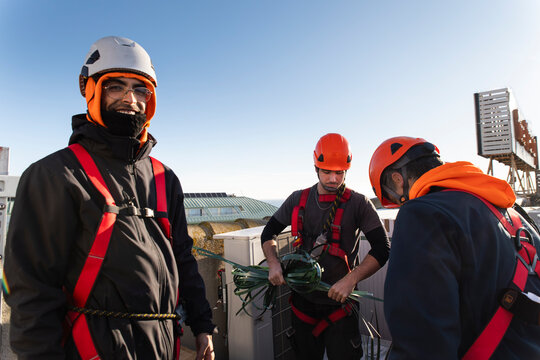 Construction workers preparing solar panel installation with teamwork outdoors