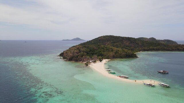 Aerial view of boats on the shore, the sand's light tones contrast with the sea's dark blue, creating a stunning visual, Coron, Mimaropa, Philippines.