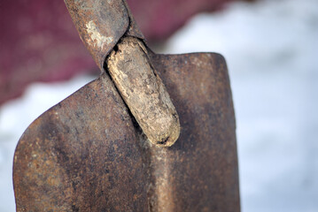 Old rusty shovel with a wooden handle