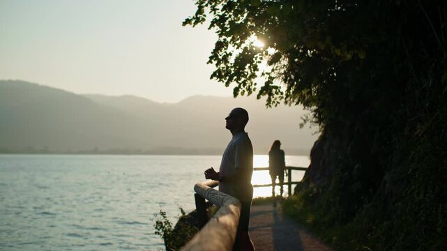 Tourist looking at lake Wolfgangsee Austria. Travel and tourism in the Alps beautiful mountains of Europe.
