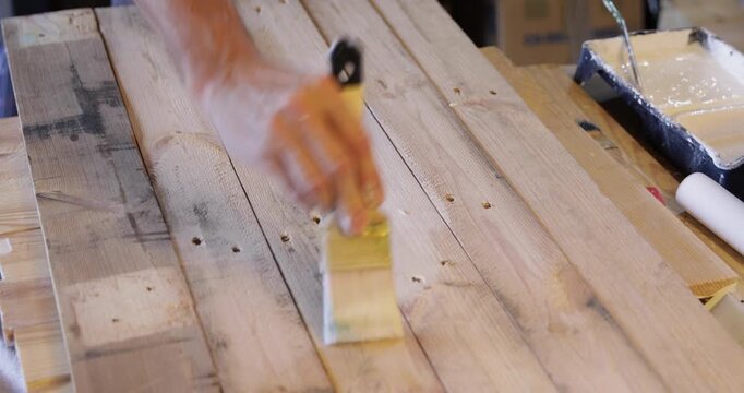 Woodworking diy wood slats painted in white using water based acrylic protective color and hand brush close up