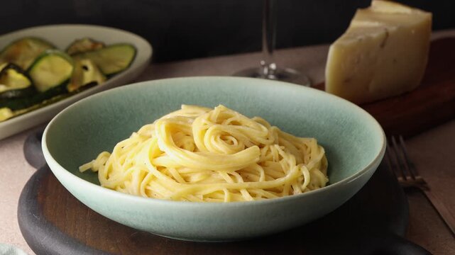 Adding, shaving black truffle to hot creamy pasta tagliolini. 