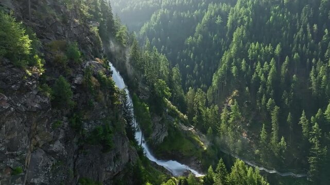 Aerial view of Stuibenfall waterfall, tourist point in the Austrian Alps. Beautiful nature of mountains, pine forests.