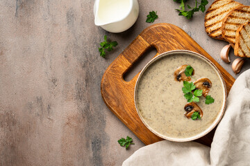 Mushroom soup puree on white kitchen table.