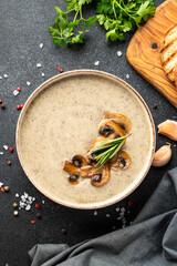 Mushroom soup puree on white kitchen table.