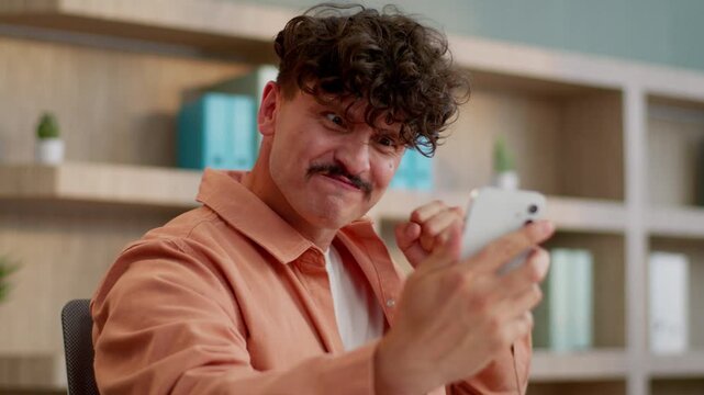 Caucasian business man winning with mobile phone app win online game businessman happy guy office worker male feeling joy happiness with internet victory achievement using cyberspace receive cashback