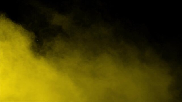 Plume of golden yellow smoke enters from left and spreads across the screen. Isolated on black background, perfect for ink drop effects, vfx compositing, and transitions