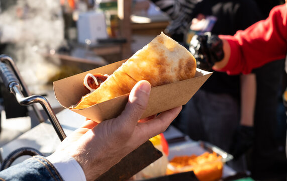fast food on the street. Sausage in pita bread, not healthy food at fairs
