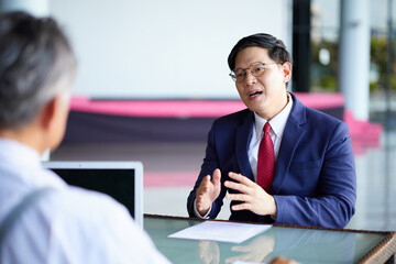 Businessman is having a conversation with a colleague in the office