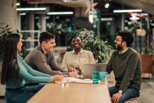 Diverse startup team colleagues collaborating enjoying meeting