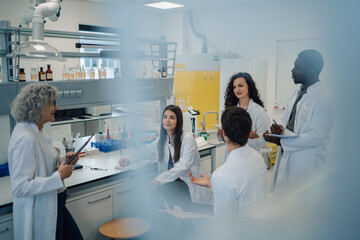 Diverse science team collaborating in research laboratory meeting