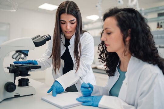 Female scientists analyzing samples in research laboratory