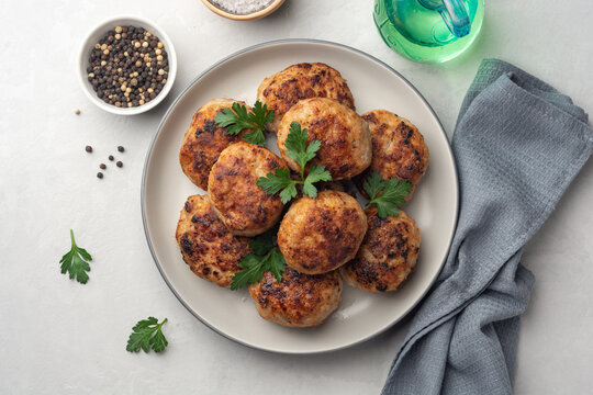 Fried meat cutlets in plate on concrete background