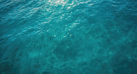 Fototapeta premium Vibrant turquoise sea with soft waves seen from aerial perspective