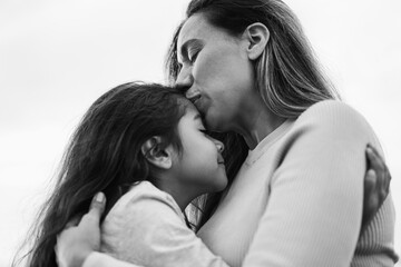 Fototapeta premium Happy latin mother and daughter enjoying time together outdoor - Love, family and mum day concept - Main focus on woman face - Black and white editing