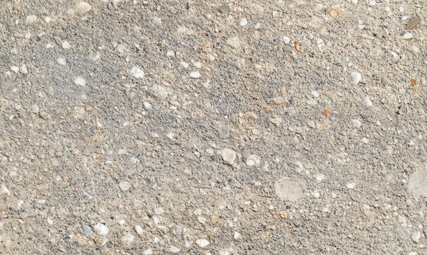 Flat texture of crushed limestone surface, pale mineral granular layer