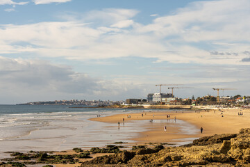Coastal panorama of Cascais beach and distant skyline