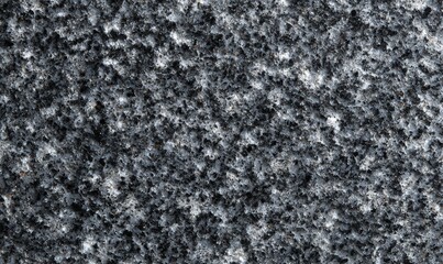 Front-facing texture of matte granite dusted surface, fine mineral grain