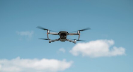 Small drone flying high with clear blue sky and copy space below