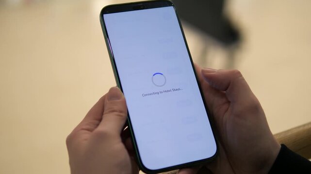 Hands holding smartphone while choosing and successfully connecting to WiFi network. Fast wireless connection, data security and modern communication concept. Perfect for technology ads, digital