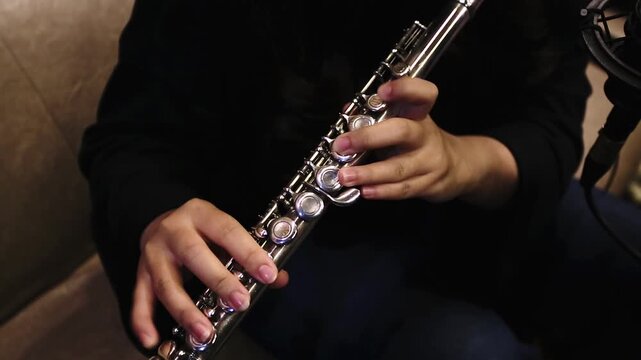 Close-Up of Musician Playing Flute in Studio