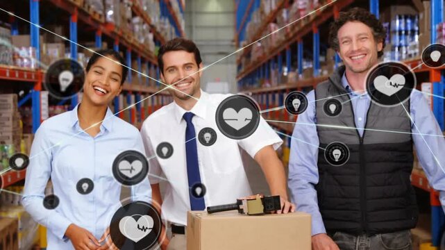 Animation of network of digital icons over team of male and female supervisors smiling at warehouse