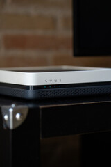 Modern home internet modem router displaying indicator lights signaling active wireless signals, broadband connection status, and networking functionality for digital devices