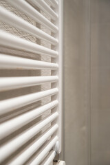 White towel radiator providing warmth and comfort in a modern bathroom, creating a minimalist concept for heating and interior design elements