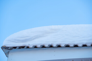 snow drifts on the roof of the house, dangerously overhanging boulders, cyclone