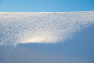 white snowdrift with blue shadows, winter texture