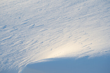 white snowdrift with blue shadows, winter texture