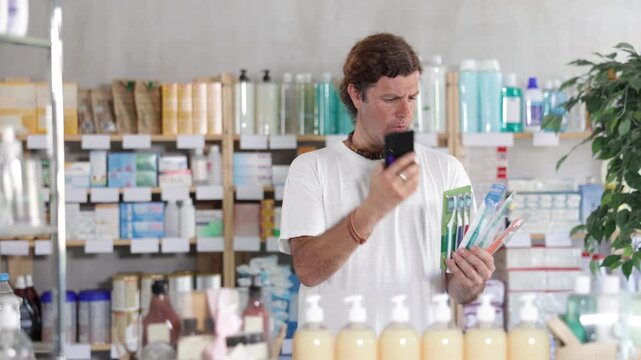 European scans the barcode on the packaging of toothbrushes on a mobile and pays using an online application on a mobile phone. Buyer in a pharmacy pays for purchases by QR. High quality 4k footage