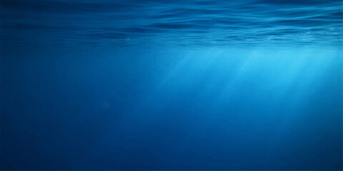 Sunlight rays pierce the deep blue ocean surface to create an abstract underwater scene where light reflections dance through the dark waves of the sea © DAKU MOHARAJ