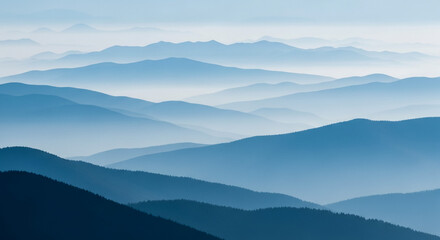 Obraz premium Majestic Blue Mountain Range Landscape with Rolling Hills and Misty Atmosphere