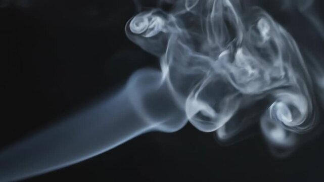 White smoke swirling on dark background with cloudy formations and misty texture