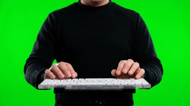 Person interacting with a computer on a green background
