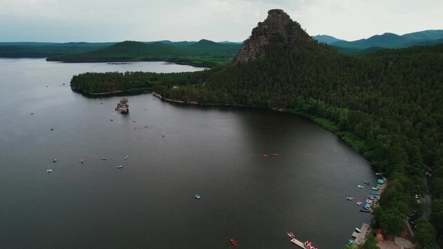 Beautiful landscape of tranquil lake with boat, forests and rocky mountains. Aerial view National nature park Burabay, Kazakhstan.