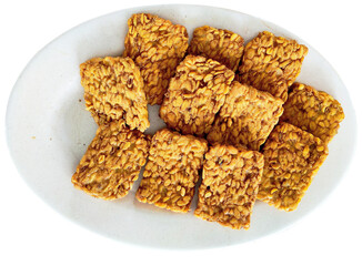 Delicious Crispy Fried Tempeh Slices on White Plate