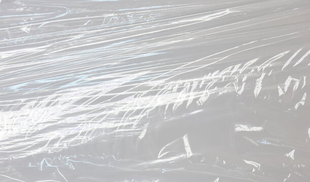 Transparent plastic wrap texture overlay. Crumpled polyethylene film, shrink packaging sheet, vinyl sleeve cover mockup. Realistic clear plastic surface effect