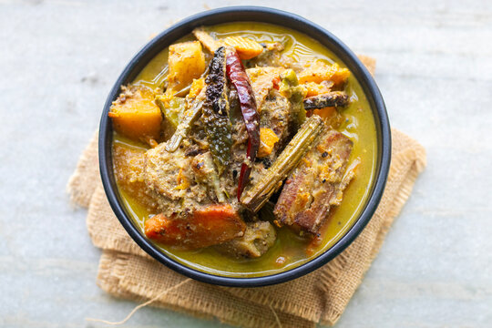 Traditional Bengali shukto is a mildly bitter vegetable curry with mustard, milk, spices, symbolizing balance, seasonality, and refined culinary wisdom.
