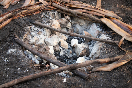Cooking cochinita pibil. The pib is an earth oven typical of the Yucat&aacute;n Peninsula in Mexico. This pre-Hispanic technique involves digging a pit, lighting a fire with wood and stones, and cooking the 