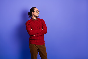 Fototapeta premium Young handsome man with glasses in red sweater posing against a violet background for lifestyle fashion and advertising photoshoot