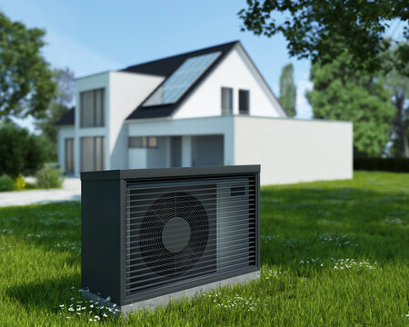 W&auml;rmepumpe im Vordergrund eines modernen Hauses mit einem unscharfen Hintergrund
