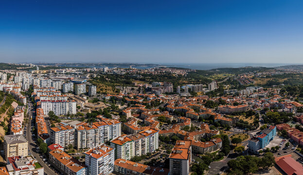 Aerial drone view of geometric Soviet-era apartment blocks in Carnaxide district in Lisbon, Portugal